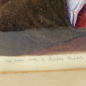 May include: A framed watercolor painting of a man with a bubble pipe. The text "The Old Man with a Bubble Bubble Pipe" is written in cursive at the bottom of the painting.