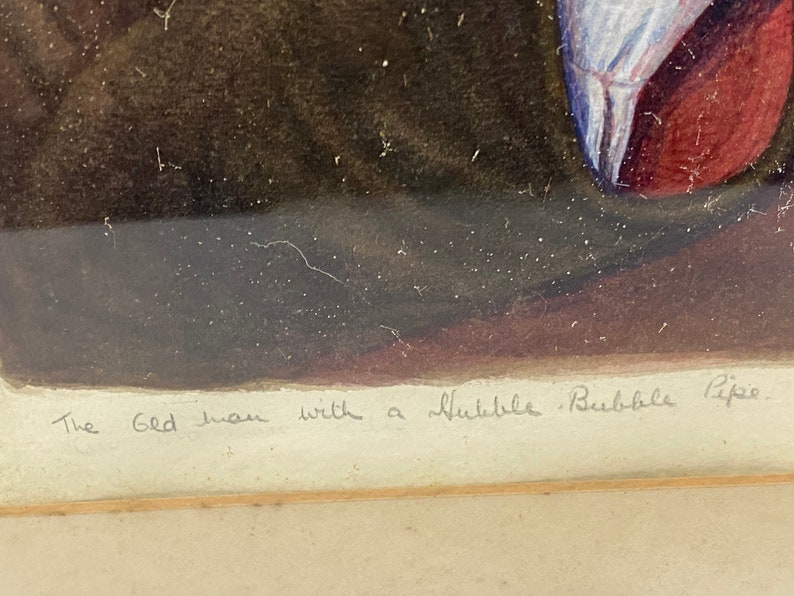 May include: A framed watercolor painting of a man with a bubble pipe. The text "The Old Man with a Bubble Bubble Pipe" is written in cursive at the bottom of the painting.