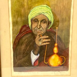 May include: A watercolor painting of an older man with a turban, wearing a brown robe, sitting and smoking a water pipe. The painting is titled "The Old Man with a Bubble Pipe" and signed "By John Platt-Mills,  Brussels,  Types, 1968."