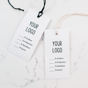 May include: Two white clothing tags with black text. The tags have the text "YOUR LOGO" and a list of fabric percentages: Cotton, Polyester, Bamboo, and Lycra.