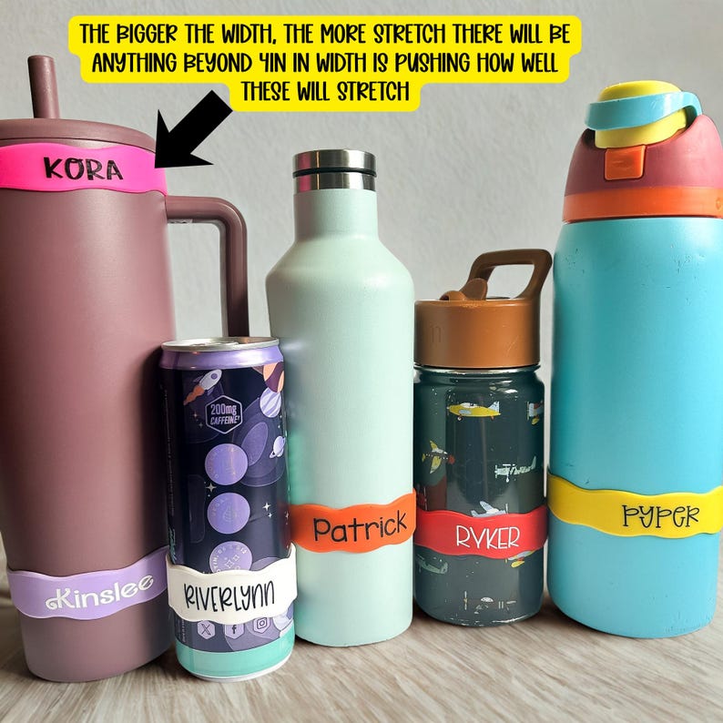 May include: Five assorted water bottles and a beverage can, each featuring a colourful silicone name band. The text on the yellow sign reads: The bigger the width, the more stretch there will be. Anything beyond 4in in width is pushing how well these will stretch.
