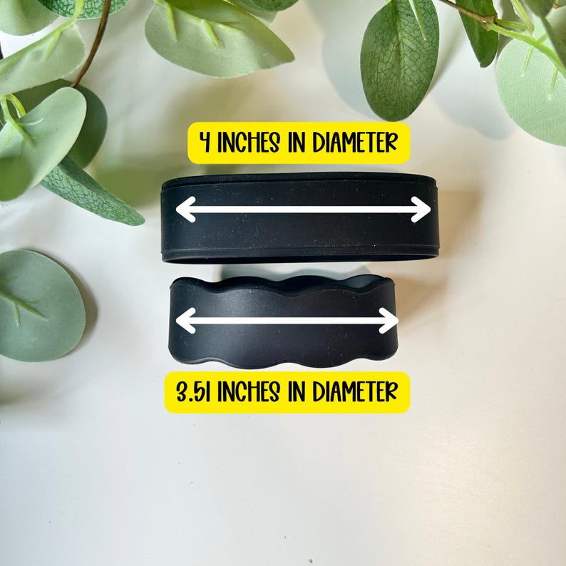 May include: Two black silicone bands. The top band is straight and measures 10.16 cm in diameter. The bottom band has a scalloped edge and measures 8.92 cm in diameter. Both bands feature white arrows indicating the measured diameter.