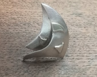 Stunning abstract silver crescent moon brooch with gilt highlights.