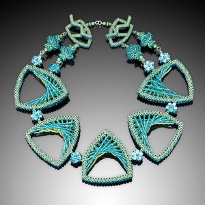 May include: A turquoise and green beaded necklace with geometric shapes. The necklace features open triangular pendants linked by beaded strands and floral details. The design uses a mix of light and dark turquoise beads, creating a striking contrast.