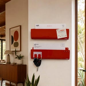 May include: Two glossy red metal wall-mounted mail organizers stacked vertically. The top organizer holds a white envelope with AARP text and a Mod Shop card. The bottom organizer holds a white envelope and has a key ring with black keys attached.