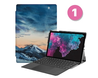 May include: A black laptop with a keyboard and a touch screen. The screen displays a colorful abstract image. The laptop is open and sitting on a table. A blue and white watercolor design case is next to the laptop.