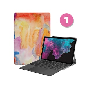 May include: A black laptop computer with a keyboard and a colorful watercolor design case. The laptop is open and the screen is displaying a colorful image. The case is a separate item.