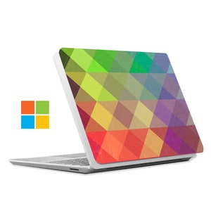 May include: White laptop with a colorful geometric pattern on the lid. The pattern is made up of triangles in shades of green, yellow, orange, red, purple, and blue.