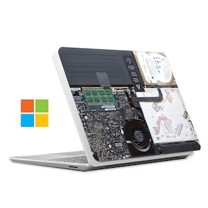 May include: A silver laptop with the bottom case removed, revealing the internal components, including the motherboard, RAM, hard drive, and cooling fan. The laptop is open and the screen is facing away from the viewer.
