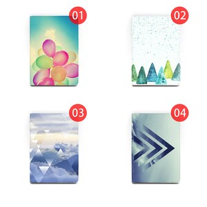 May include: Four different designs for a notebook cover. The first design features a cluster of colorful balloons against a blue sky. The second design features a white background with a pattern of small white dots and a row of green trees at the bottom. The third design features a blue and white geometric pattern with a mountain range in the background. The fourth design features a blue and white geometric pattern with a diagonal arrow shape.