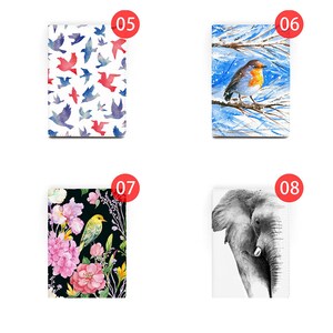 May include: Four different designs for a passport cover. The first design features a white background with a pattern of red and blue birds. The second design features a blue and white watercolor background with a red robin perched on a branch. The third design features a black background with pink flowers and a yellow bird. The fourth design features a white background with a black and white drawing of an elephant.