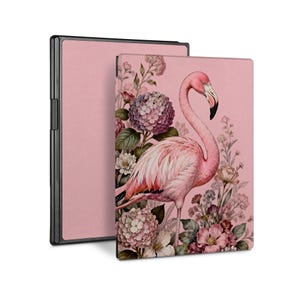May include: A pink e-reader case featuring a flamingo illustration. The flamingo is surrounded by flowers in shades of pink, purple, and white. The case has a black frame and a solid pink back.