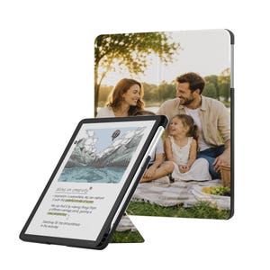 May include: A black tablet case featuring a custom photo print of a family having a picnic on the front cover. The tablet screen displays a digital illustration of mountains and a hot air balloon with the text Notes on creativity and other text.