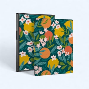 May include: Two notebooks with a dark green background and a floral pattern featuring lemons, oranges, and white flowers. The notebooks are closed and standing upright.