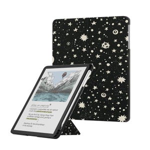 May include: A black tablet case featuring a white star and planet pattern, displayed with a tablet showing a mountain landscape illustration and the text Notes on creativity, Inspiration is everywhere, we can capture it with the colorful stroke of a pen.