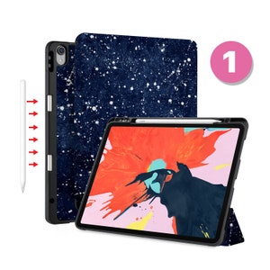 May include: A navy blue and white galaxy print iPad case with a black iPad and a white stylus. The case has a built-in stand.