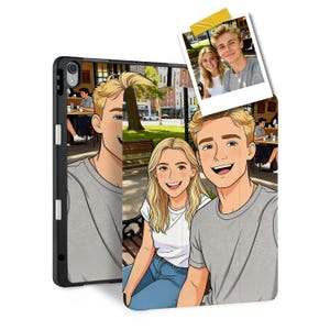 May include: A black iPad case with a custom cartoon portrait of a smiling couple. The case features a photo of the couple and a cartoon illustration. The couple is blonde and wearing casual clothing. A yellow sticky note is attached to the photo.