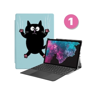 May include: A black laptop with a blue and purple abstract design on the screen. The laptop is closed and has a black keyboard and trackpad. The laptop is sitting on a blue background with a black cat with pink paws scratching at the screen.