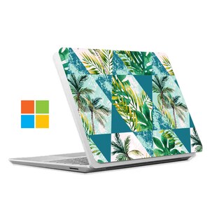 May include: A white laptop with a tropical leaf pattern on the lid. The pattern features green leaves and palm trees on a teal and white background.