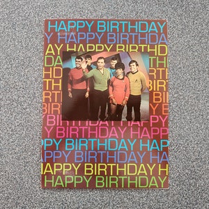 May include: A colorful birthday card featuring a photo of the original Star Trek cast. The card has the words "Happy Birthday" repeated in a rainbow of colors.