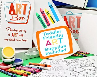 Puede incluir: Una caja blanca con el texto "My Art Box Toddler Fun Creativity Box" y un corazón rojo con el texto "I Love Art". La caja está llena de materiales de arte, incluyendo crayones, pintura y páginas para colorear. El texto "Sharing the joy of ART with one child at a time!" está en un libro blanco con un logotipo rojo, naranja y amarillo que dice "My Art Box".