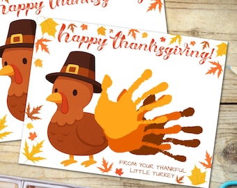 May include: Two Thanksgiving greeting cards with cartoon turkeys wearing pilgrim hats. One card features a handprint turkey. The cards have the text "Happy Thanksgiving!" and "From Your Thankful Little Turkey."