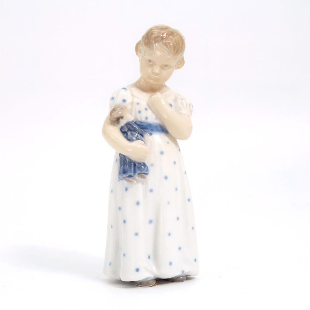 A porcelain Royal Copenhagen figure 3539 "Girl with doll", 144mm tall