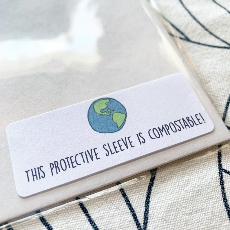 May include: A white label with a green and blue globe illustration and the text "THIS PROTECTIVE SLEEVE IS COMPOSTABLE!"