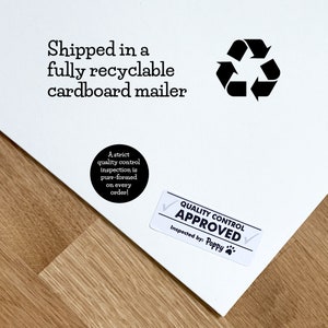 May include: White cardboard mailer with black text that reads "Shipped in a fully recyclable cardboard mailer". A black recycling symbol is on the right side of the text. A black circle sticker with white text that reads "A strict quality control inspection is purr-formed on every order!" is on the left side of the image. A white rectangle sticker with black text that reads "QUALITY CONTROL APPROVED" and "Inspected by: Poppy" is on the bottom right corner of the image.