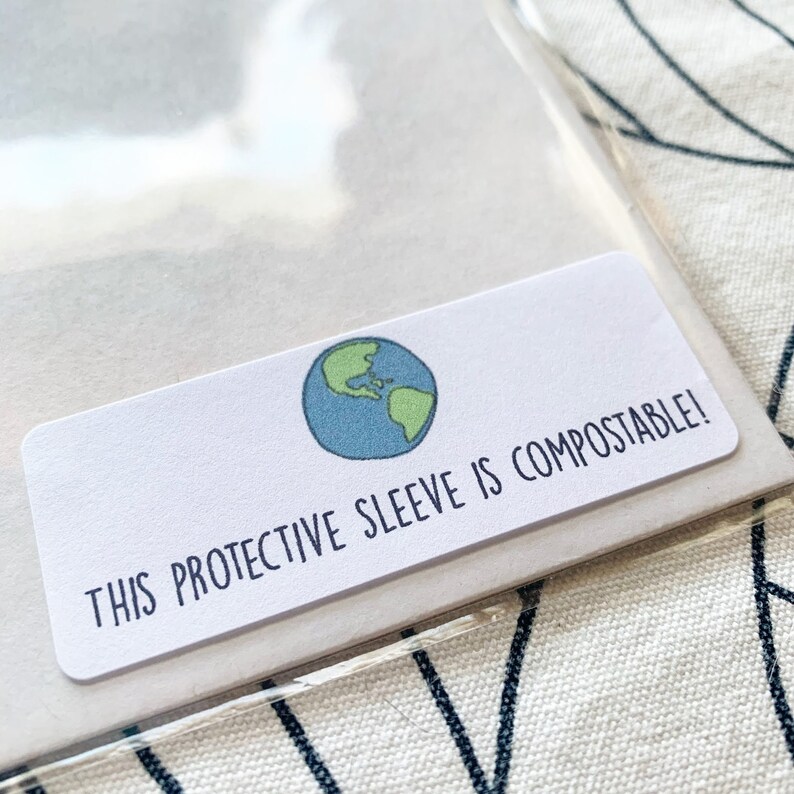 May include: A white label with a green and blue globe illustration and the text "THIS PROTECTIVE SLEEVE IS COMPOSTABLE!"
