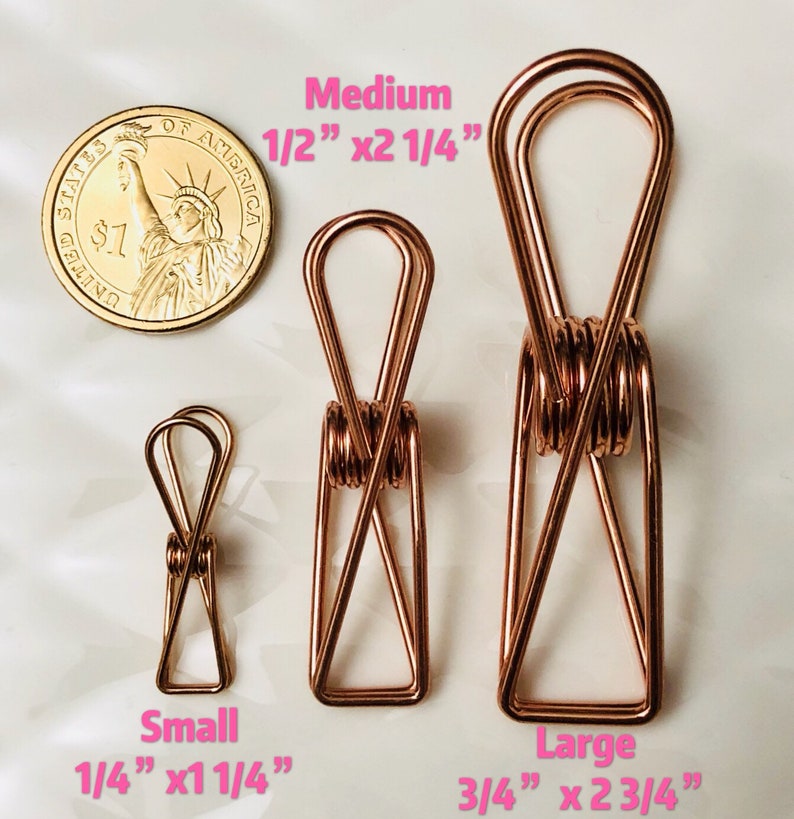 May include: Three gold-toned metal binder clips of different sizes. The smallest clip is 1/4 inch by 1 1/4 inch, the medium clip is 1/2 inch by 2 1/4 inch, and the largest clip is 3/4 inch by 2 3/4 inch.