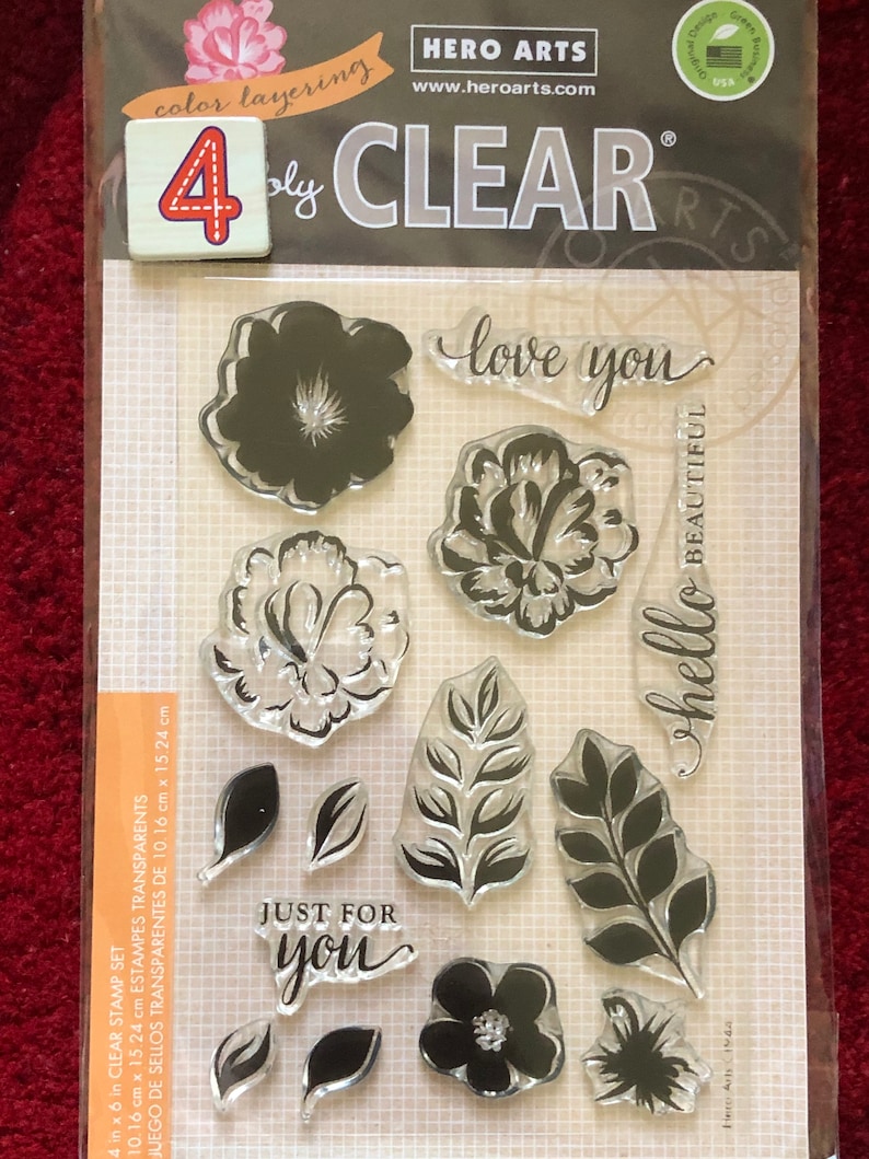 May include: A set of 4x6 inch clear stamps with floral and leaf designs. The stamps include the phrases "love you", "hello beautiful", and "just for you".