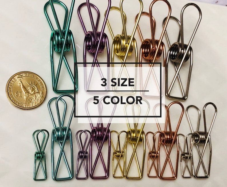 May include: A variety of colorful metal binder clips in three sizes. The clips are arranged in rows and are available in five colors: green, purple, gold, copper, and silver. The text "3 SIZE 5 COLOR" is printed on a white background.