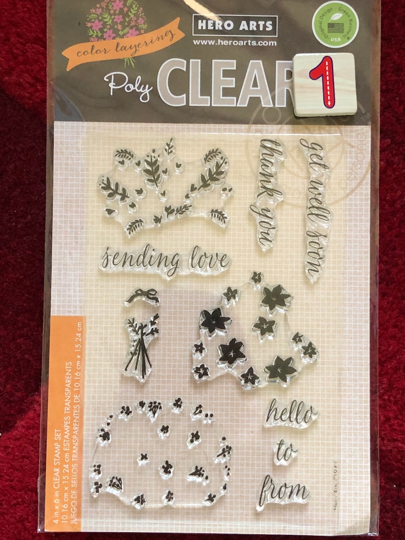 May include: A clear stamp set with the text "sending love", "thank you", "get well soon", "hello to from" and floral designs. The set is 4 inches by 6 inches.
