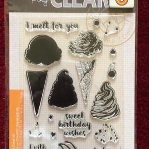 May include: A set of 6 clear polymer stamps featuring ice cream themed images and phrases like "I melt for you", "Sweet birthday wishes", and "What's the scoop?" The stamps are 4 inches by 6 inches (10.16 cm x 15.24 cm).