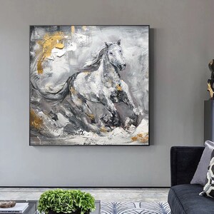 May include: Abstract painting of a white horse running through a grey and gold landscape. The horse is painted in a realistic style with a textured brushstroke. The background is a mix of grey, white, and gold.