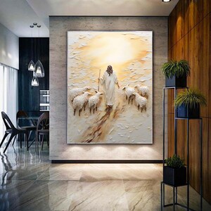 May include: A painting of a person in white robes walking with a flock of sheep in a field. The background is a bright yellow and orange sunset.