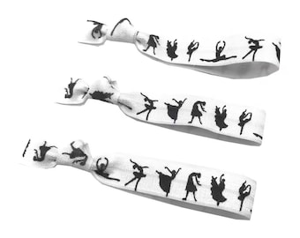 May include: Three white elastic hair ties with a black silhouette of a ballerina printed on each tie.