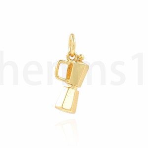 May include: A gold-coloured charm in the shape of a coffee pot.