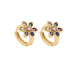 May include: A pair of gold hoop earrings with a flower design. The flower has a center stone and six surrounding stones in various colors, including pink, blue, green, and purple.
