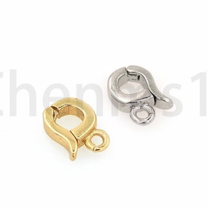 May include: Two metal clasps for jewelry making. One is gold and the other is silver.