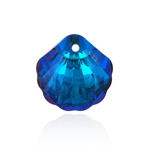 May include: A blue crystal seashell pendant charm with a faceted design.