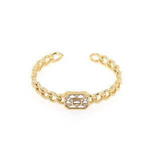 May include: A gold chain ring with a rectangular clear crystal centerpiece.