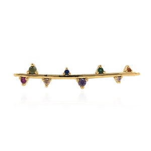 May include: A gold bar earring with a row of colourful gemstones. The gemstones are red, pink, green, blue, purple, and clear.