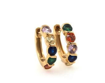 May include: A pair of gold hoop earrings with colorful gemstones. The earrings have a total of six gemstones, each a different color: pink, yellow, blue, green, orange, and purple.