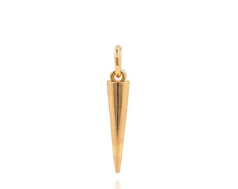 May include: A gold-colored metal pendant shaped like a sharp point. The pendant has a loop at the top for attaching to a chain or cord.