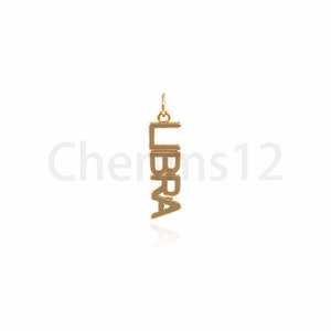 May include: Gold-colored pendant charm with the word "LIBRA" spelled vertically.