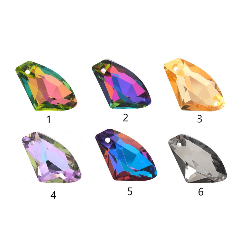 May include: Six iridescent glass rhinestones in various colors, including green, purple, blue, and gold. Each rhinestone has a teardrop shape with a pointed tip and a flat back.