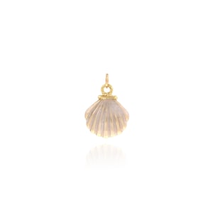 May include: A gold-colored seashell pendant with a small loop at the top for a chain. The pendant has a textured, ridged surface and a light beige color. The pendant is a jewelry item.