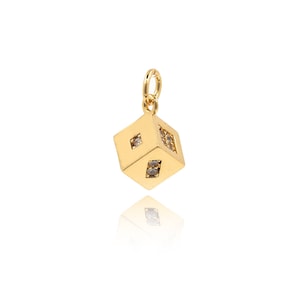 May include: Gold-tone charm in the shape of a cube with clear cubic zirconia stones set into the sides. The charm has a loop at the top for attaching to a necklace or bracelet.